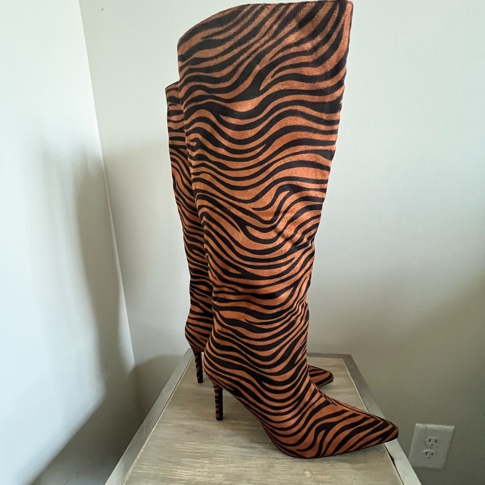 Zebra Print knee length heeled boots.